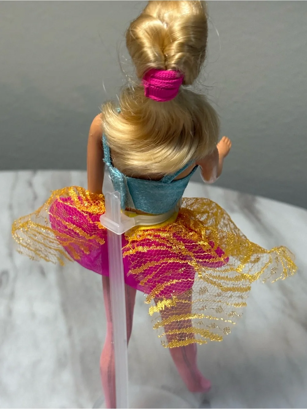 vintage blonde 1998 Bubble Fairy Barbie doll wearing a light blue top and a pink